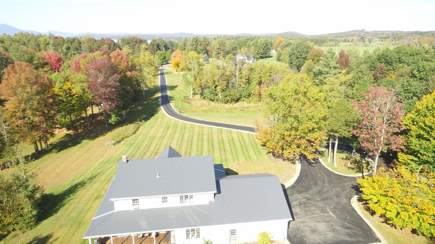 Aerial of a finished Vermont driveway and circular parking pad in fall