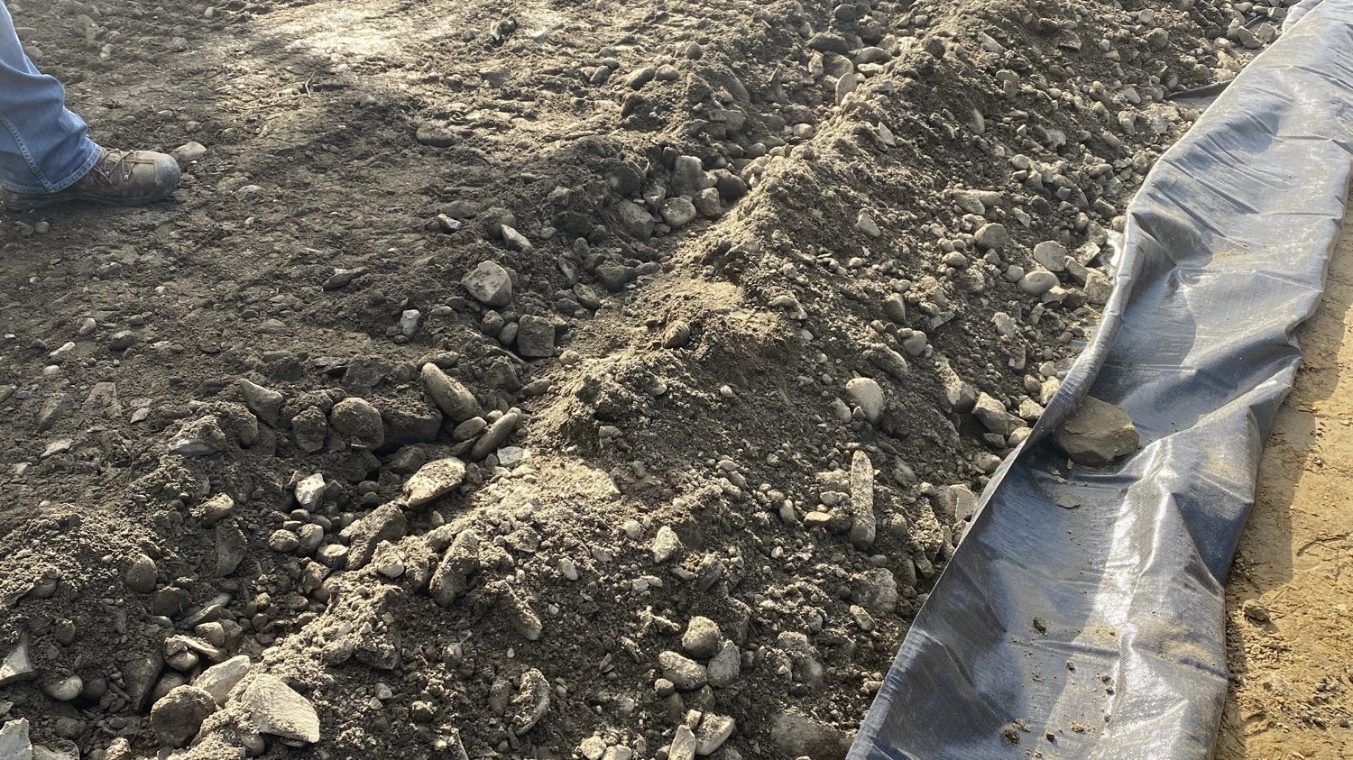 Gravel base and silt fence ready for new asphalt