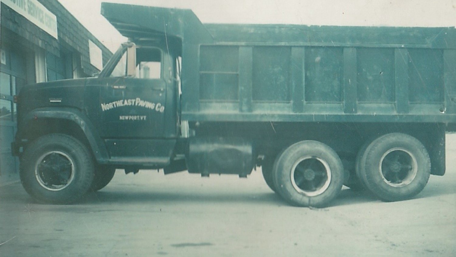 Archive photo of a Northeast Paving Co dump truck with Newport, VT on the door