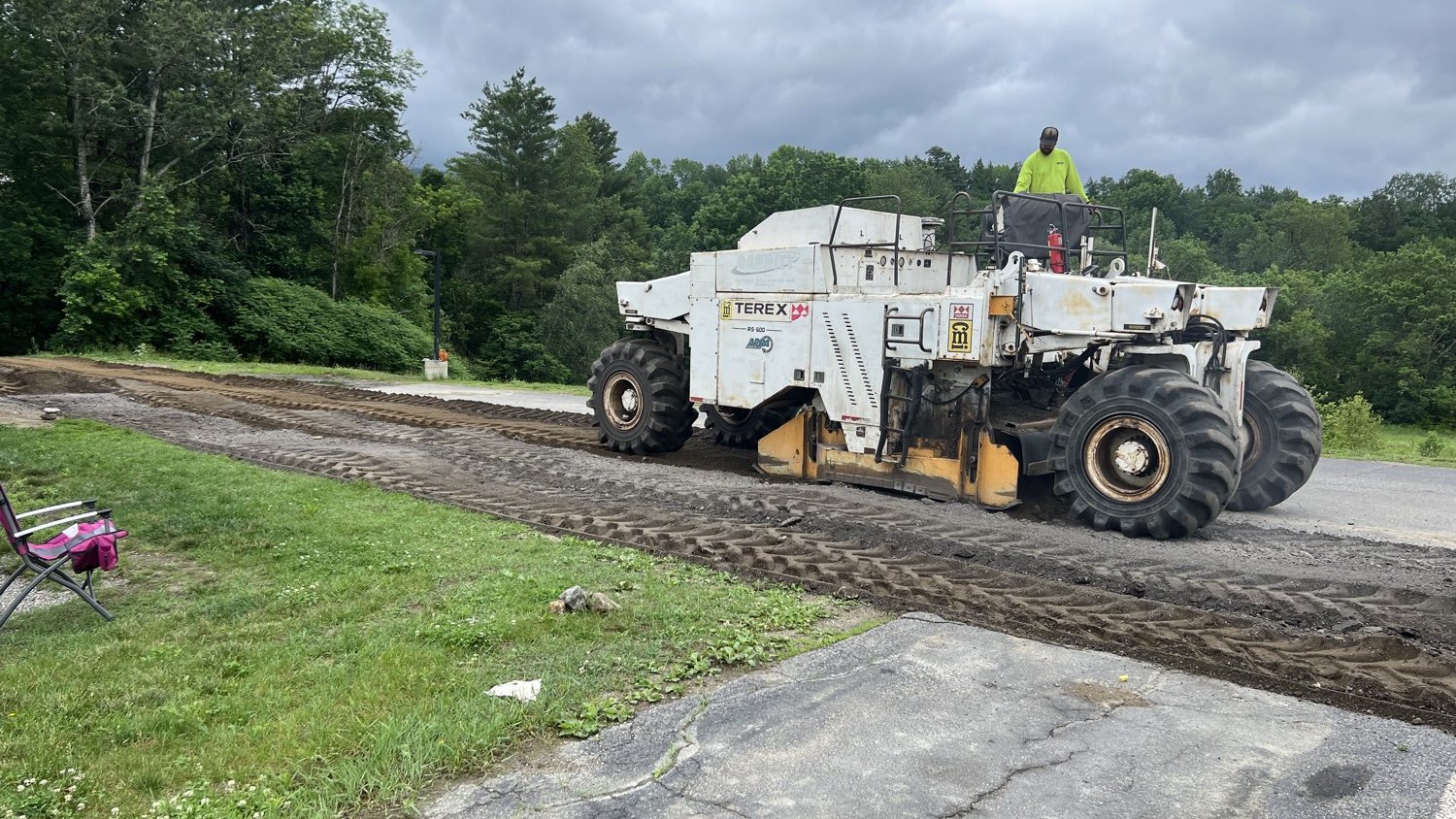 Reclaimer grinding old pavement to prep a driveway