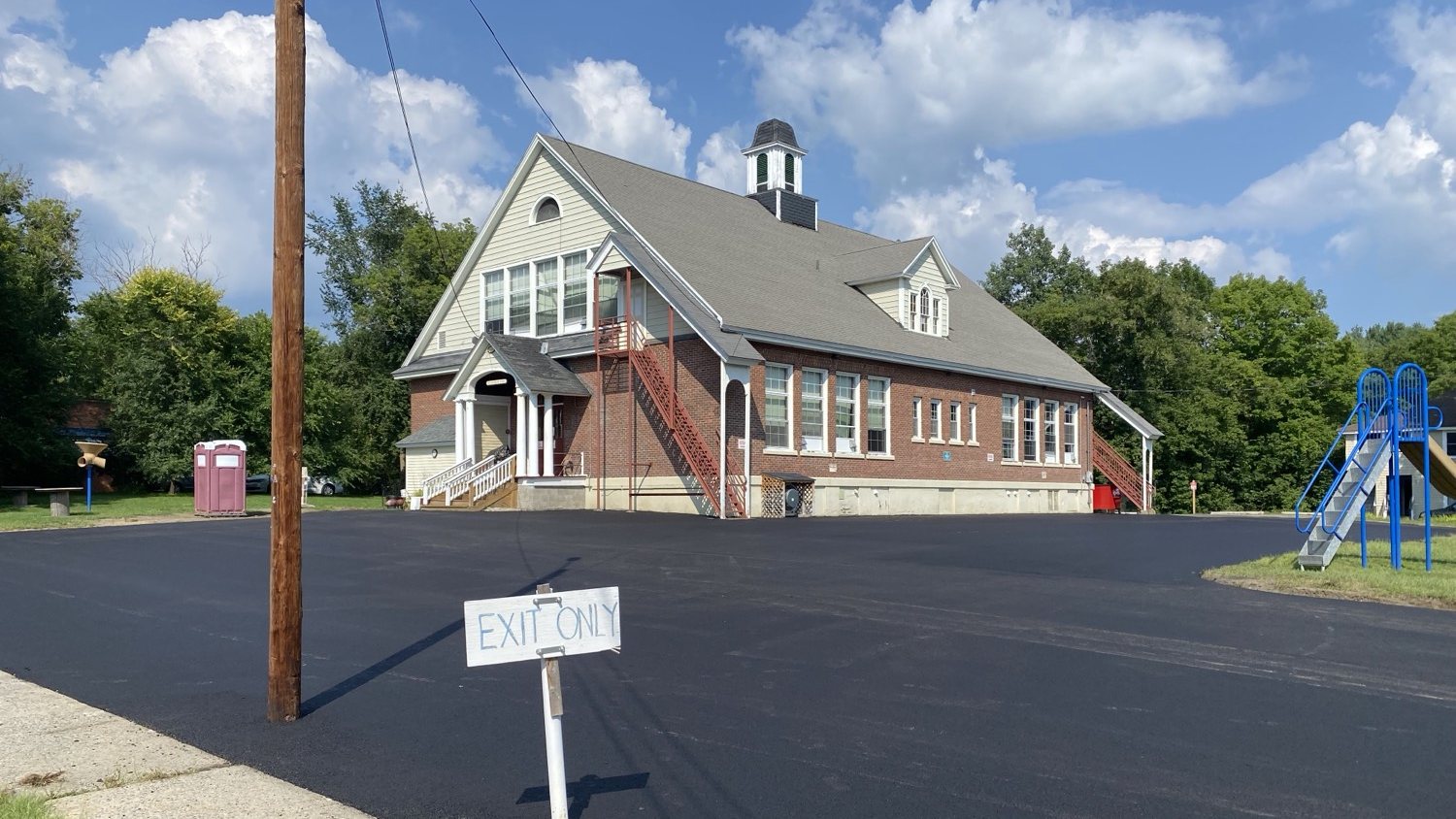 Newly paved school parking lot with playground in Vermont